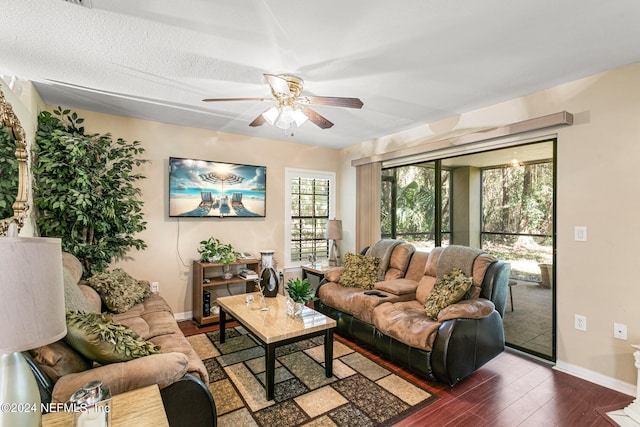 living room with ceiling fan, a textured ceiling, and dark hardwood / wood-style flooring