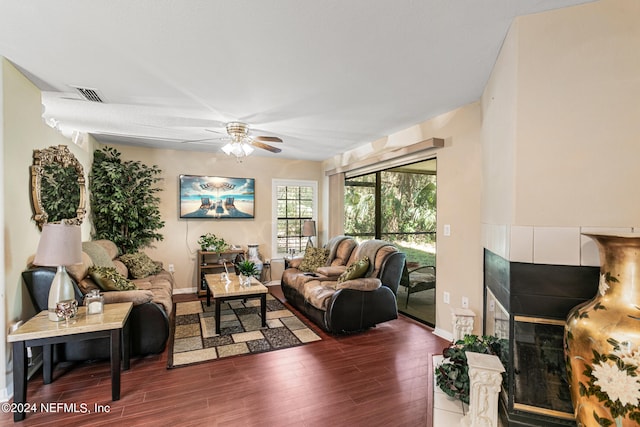 living room with dark hardwood / wood-style floors and ceiling fan