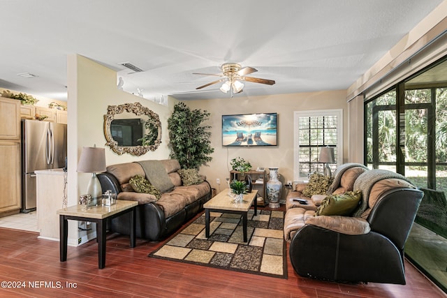 living room with ceiling fan and dark hardwood / wood-style flooring