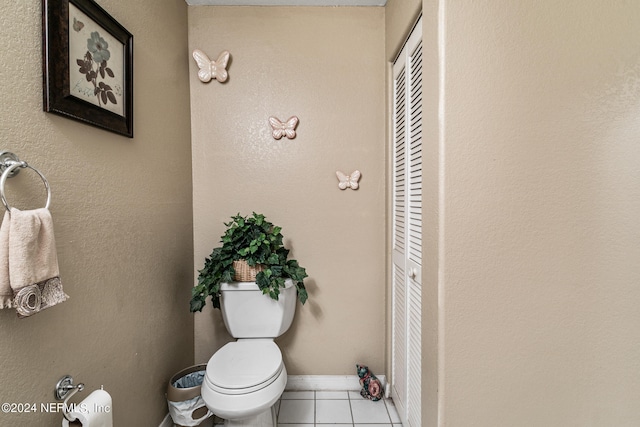 bathroom featuring toilet and tile patterned flooring