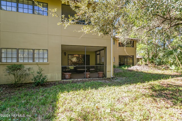 rear view of house featuring a yard