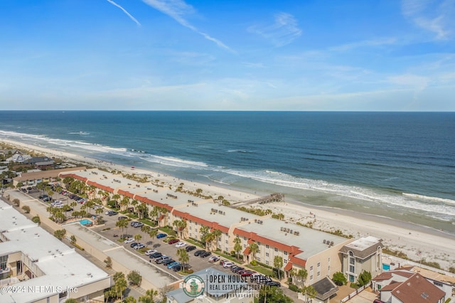 birds eye view of property with a view of the beach and a water view