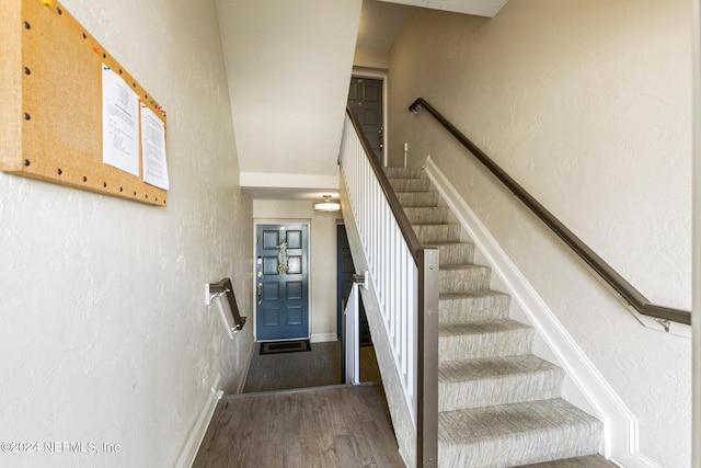 10 10th St Unit 37, Atlantic Beach, FL 32233 - staircase with a textured wall, baseboards, and wood finished floors