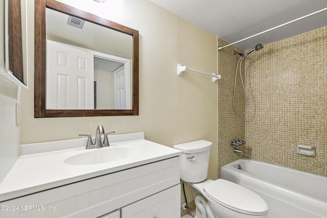 full bathroom featuring vanity, toilet, and tiled shower / bath