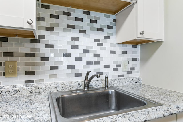 10 10th St Unit 37, Atlantic Beach, FL 32233 - room details with light stone counters, white cabinets, decorative backsplash, and a sink