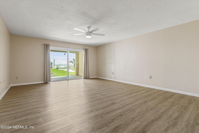 10 10th St Unit 37, Atlantic Beach, FL 32233 - empty room featuring wood finished floors, a textured ceiling, a ceiling fan, and baseboards