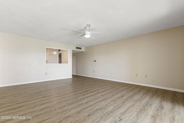 spare room with hardwood / wood-style flooring and ceiling fan