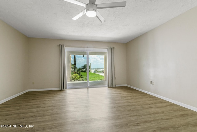 empty room with wood-type flooring, a textured ceiling, and ceiling fan