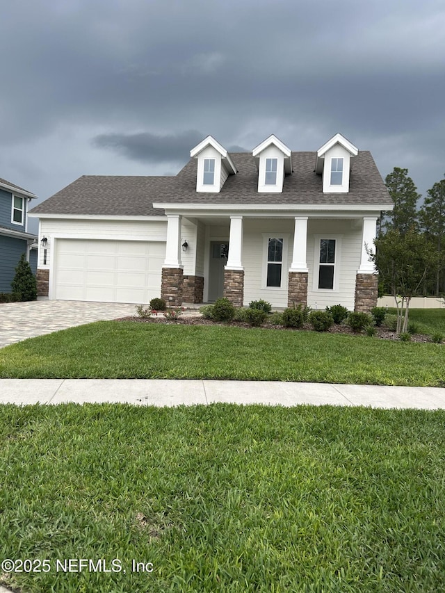 49 Pathway Ct, Saint Johns, FL 32259 - view of front of house featuring stone siding, driveway, and roof with shingles