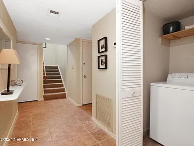 clothes washing area with washer / dryer