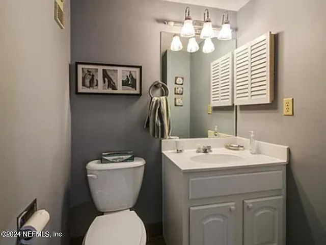 bathroom featuring toilet and vanity