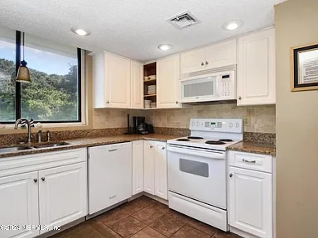 kitchen with decorative backsplash, sink, white appliances, and white cabinetry