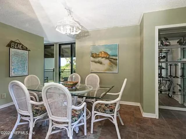 dining space with an inviting chandelier and a textured ceiling