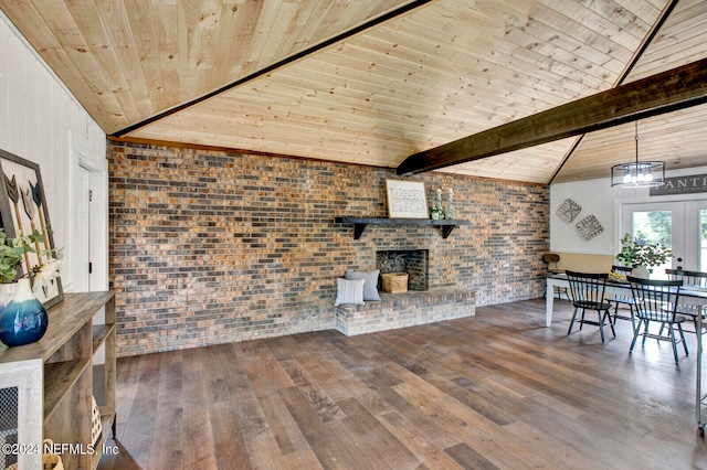 living room featuring brick wall, vaulted ceiling with beams, and hardwood / wood-style flooring