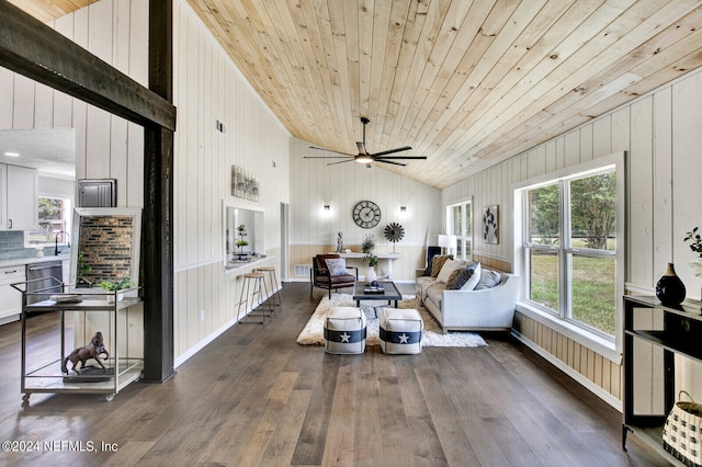 living room with wooden walls, dark wood-type flooring, vaulted ceiling, and wood ceiling