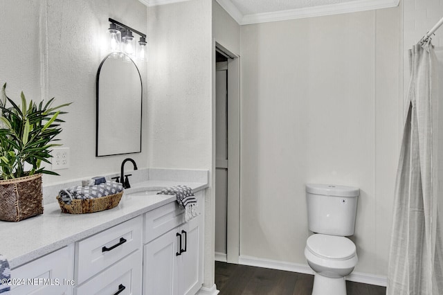 bathroom featuring hardwood / wood-style floors, vanity, toilet, and ornamental molding