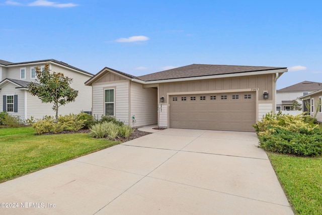 view of front of house with a front yard and a garage