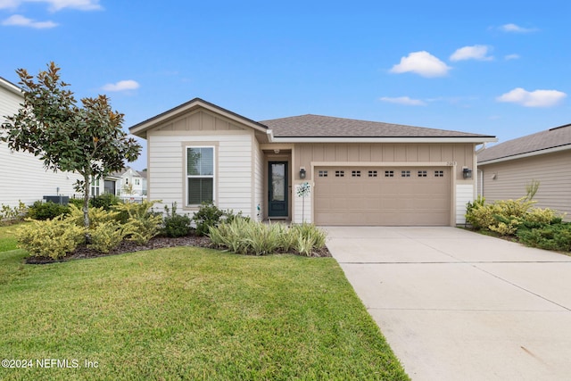 view of front of property featuring a front lawn and a garage