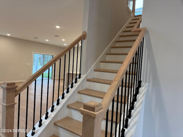 staircase with wood-type flooring