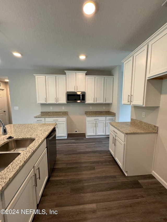 kitchen with dark wood-type flooring, stainless steel appliances, and white cabinets