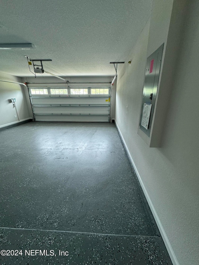 garage featuring electric panel and a garage door opener