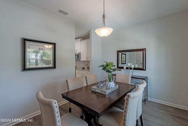 dining area with dark hardwood / wood-style floors