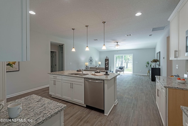 kitchen featuring sink, an island with sink, white cabinetry, dark hardwood / wood-style flooring, and stainless steel dishwasher