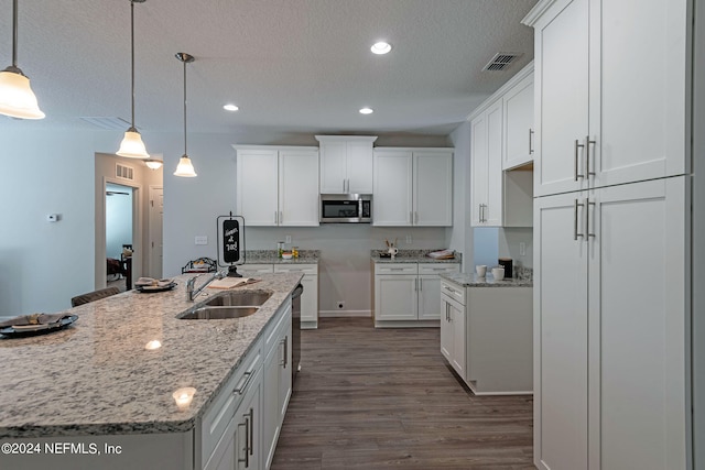 kitchen featuring white cabinetry, sink, decorative light fixtures, and dark hardwood / wood-style flooring