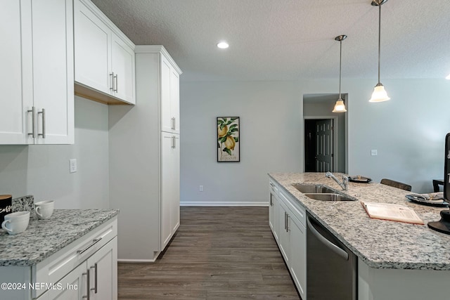 kitchen with white cabinetry, dishwasher, pendant lighting, a kitchen island with sink, and sink