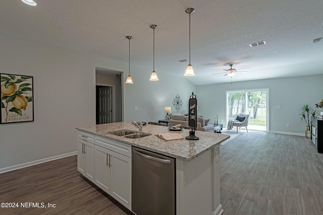 kitchen featuring dark wood-type flooring, white cabinets, light stone countertops, stainless steel dishwasher, and sink