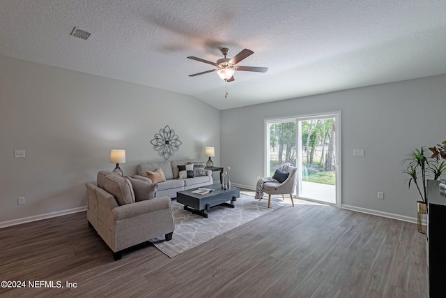 living room with ceiling fan, a textured ceiling, lofted ceiling, and dark hardwood / wood-style floors