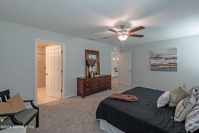 carpeted bedroom with a textured ceiling and ceiling fan