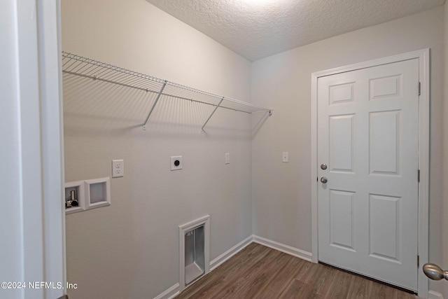 washroom with a textured ceiling, electric dryer hookup, hookup for a washing machine, and dark wood-type flooring