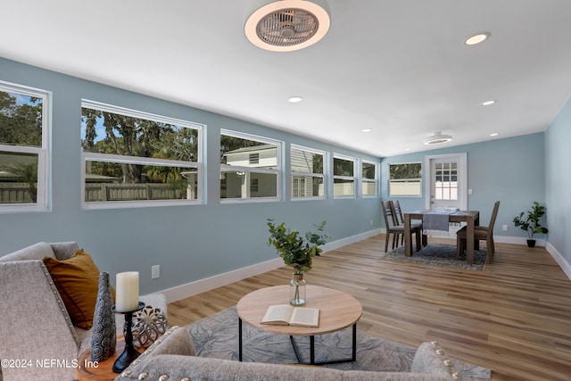 living room featuring wood-type flooring and vaulted ceiling