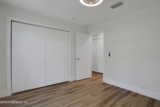 unfurnished bedroom with light wood-type flooring