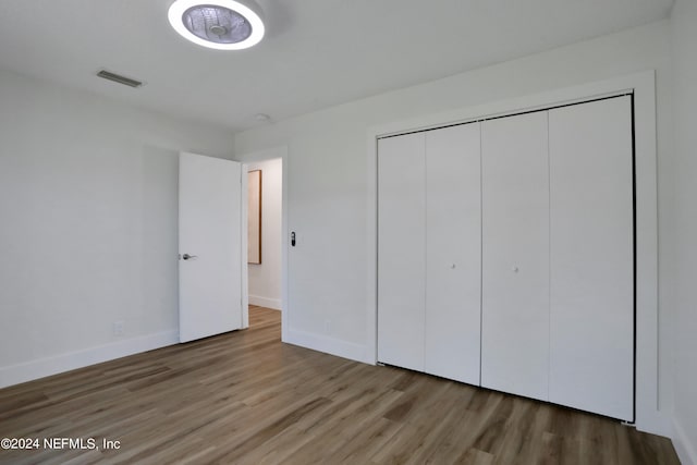 unfurnished bedroom featuring a closet and wood-type flooring