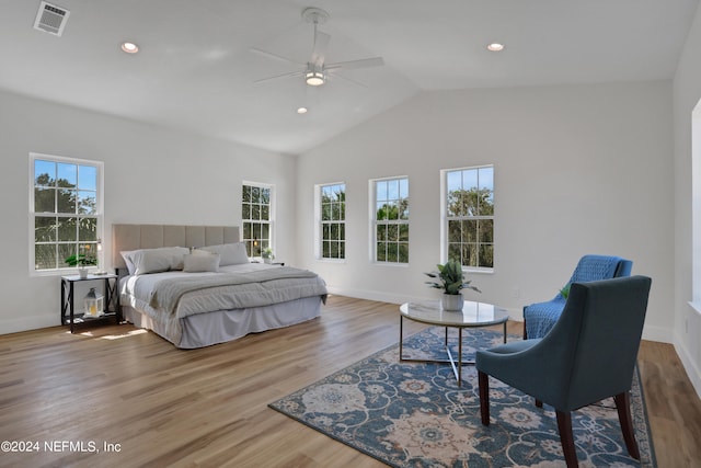 bedroom with wood-type flooring, multiple windows, ceiling fan, and vaulted ceiling