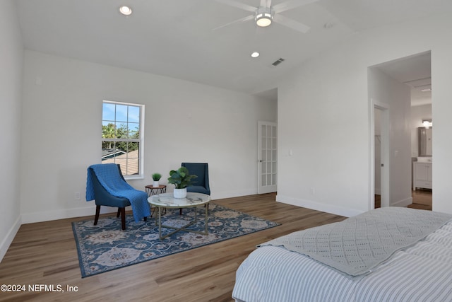 bedroom featuring hardwood / wood-style flooring, ceiling fan, vaulted ceiling, and ensuite bathroom