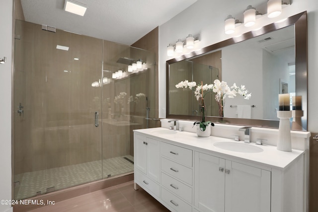 bathroom featuring walk in shower, tile patterned flooring, vanity, and a textured ceiling