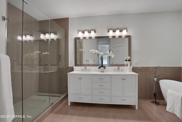 bathroom with walk in shower, vanity, and a textured ceiling