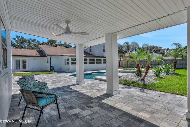 view of patio with ceiling fan, a fenced in pool, and french doors