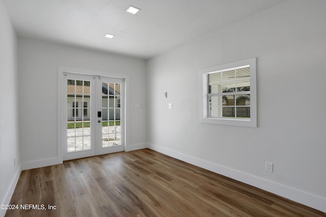 unfurnished room featuring french doors and hardwood / wood-style flooring