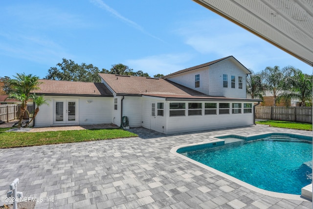 view of swimming pool with a patio and french doors