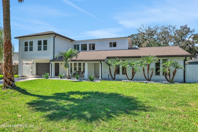 view of front of home featuring a garage and a front lawn