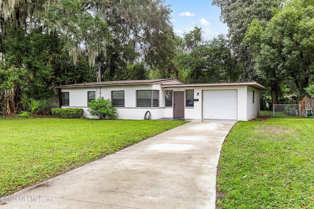 ranch-style house with a garage and a front lawn