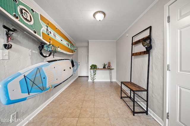 interior space featuring light tile patterned floors and crown molding