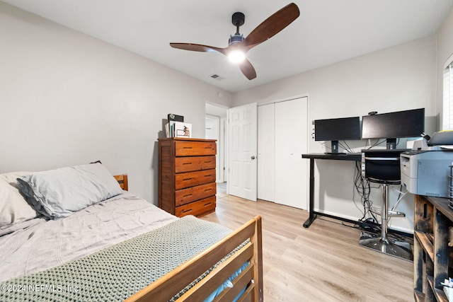 bedroom featuring light hardwood / wood-style flooring, a closet, and ceiling fan