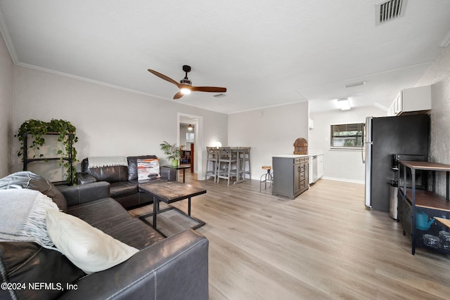 living room with ceiling fan, light hardwood / wood-style floors, and crown molding