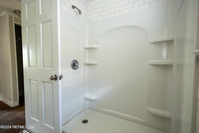 bathroom featuring a shower and hardwood / wood-style flooring