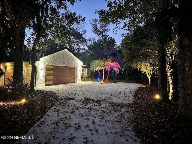 exterior space with a garage and a water view